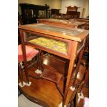 An Edwardian mahogany and banded bijouterie table, on square taper supports united by an