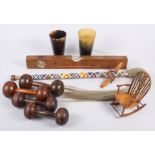 A pair of horn beakers, two pairs of turned wood dumbbells, a wooden mounted spirit level, a