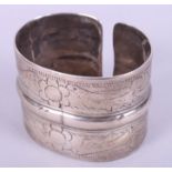A Middle Eastern white metal cuff bracelet, decorated birds and feathers
