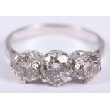 A diamond three stone ring, in white metal mount, stamped 18ct, size M