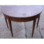 An Edwardian semi-circular fold-over card table, on square taper supports, 39 1/4" wide