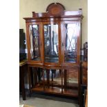 An Edwardian walnut and satinwood banded break bowfront display cabinet enclosed two doors over