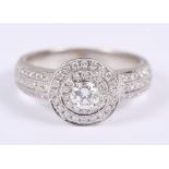 A 9ct white gold and diamond ring, central stone surrounded two bands of channel set diamonds and