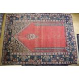 A Persian prayer rug with red central ground, flanking columns and a lantern, 55" x 76" approx (