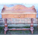 A mahogany serpentine front washstand with raised back, fitted one drawer, on stretchered
