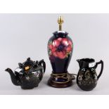 A Moorcroft "Anemone" pattern table lamp, 14 1/2" high overall, a Queen Victoria commemorative jug