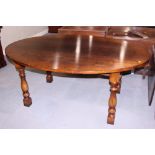 A Titchmarsh and Goodwin oak oval top dining table, on turned supports, 60" x 75"