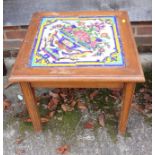 A pine framed Portuguese floral and bird decorated tile top table, 20" square