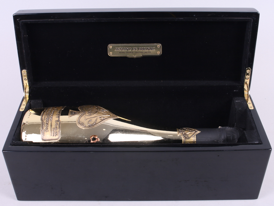 A bottle of Armand de Brignac Ace of Spades champagne, in black lacquered presentation box