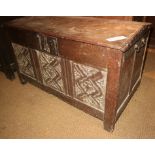 A late 17th century oak triple carved panel front Hanseatic oak coffer with wrought iron carry