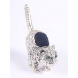 A white metal pin cushion, formed as a cat with gem set eyes, stamped sterling, 1 1/4" high