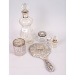 A silver collared decanter, a floral swag decanter, a silver and enamel topped scent bottle, a white