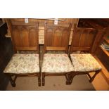 A set of four oak Gothic arch panel back standard dining chairs, on turned and stretchered supports