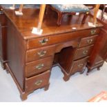 A Georgian mahogany kneehole desk fitted cupboard and 7 drawers on bracket feet.