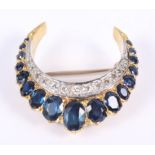 A sapphire and diamond crescent moon brooch, in yellow metal mount