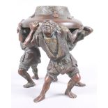 A late 19th century Japanese bronze urn, supported by three men, 7" high