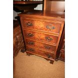 A figured mahogany and banded chest of four drawers, on bracket feet, 10 1/2" wide