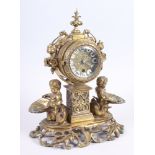 A late 19th century brass mantel clock, flanked cherubs holding shells, 12" high