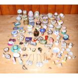 A quantity of china pill boxes, a white metal topped shell bottle, various china model animals and