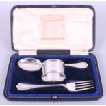 A silver three-piece christening set, comprising a matching spoon, fork and napkin ring, 3oz troy