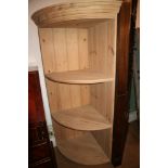 A pine corner unit with three open shelves, 55" high x 28 1/2" wide