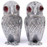 A pair of salt and pepper shakers, formed as owls with red paste eyes, 2 3/4" high