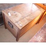 An Arts & Crafts oak plank coffer with wrought iron carry handles on strap hinges, on stile