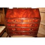 A figured mahogany and banded fall front bureau of Georgian design with fitted interior over two