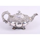 A Victorian silver squat melon shaped teapot with 'C' scroll handle, embossed floral decoration