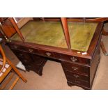 An early 20th century mahogany double pedestal desk with green tooled leather lined top, fitted nine