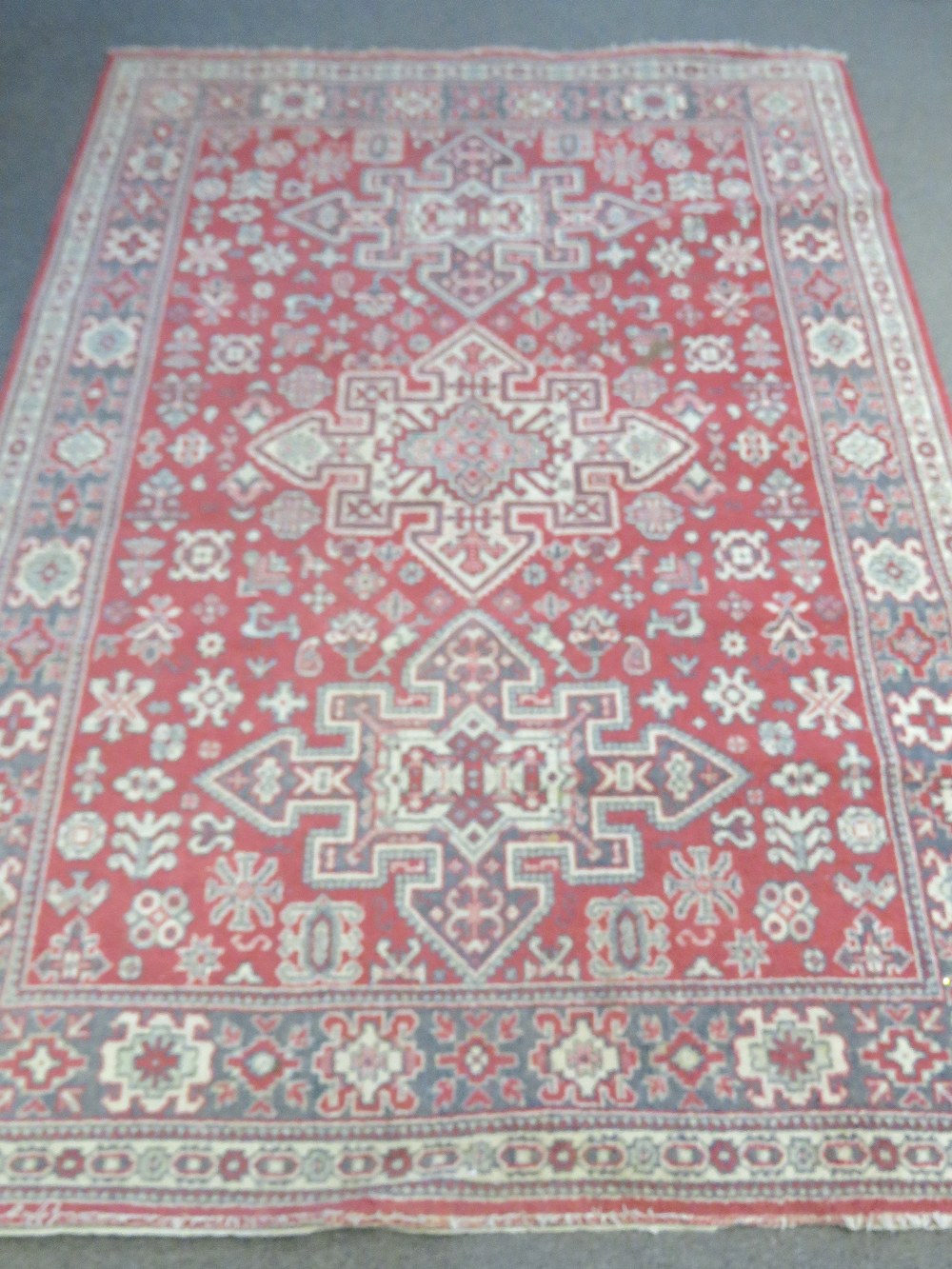 A Wilton bordered rug with three central