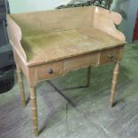 A Victorian pine washstand having twin b