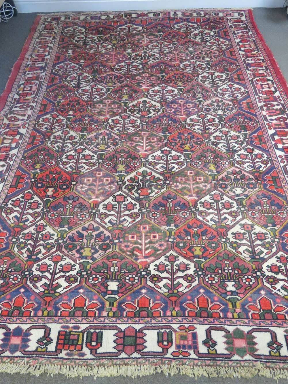 A 20thC Middle Eastern bordered carpet w