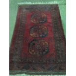 A red ground Middle Eastern rug having t