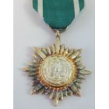 A WWII German Easter Peoples medal with swords, having original green ribbon.