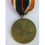 A WWII German War Merit Cross (Fur Kriegs-Verdient) 1939 medal with ribbon.