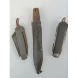 Two British Military Naval pocket knives; one WWII era and one filleting knife in leather sheath.