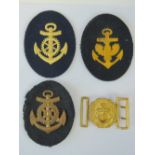 A quantity of Naval cloth badges and a Naval Officers belt buckle.