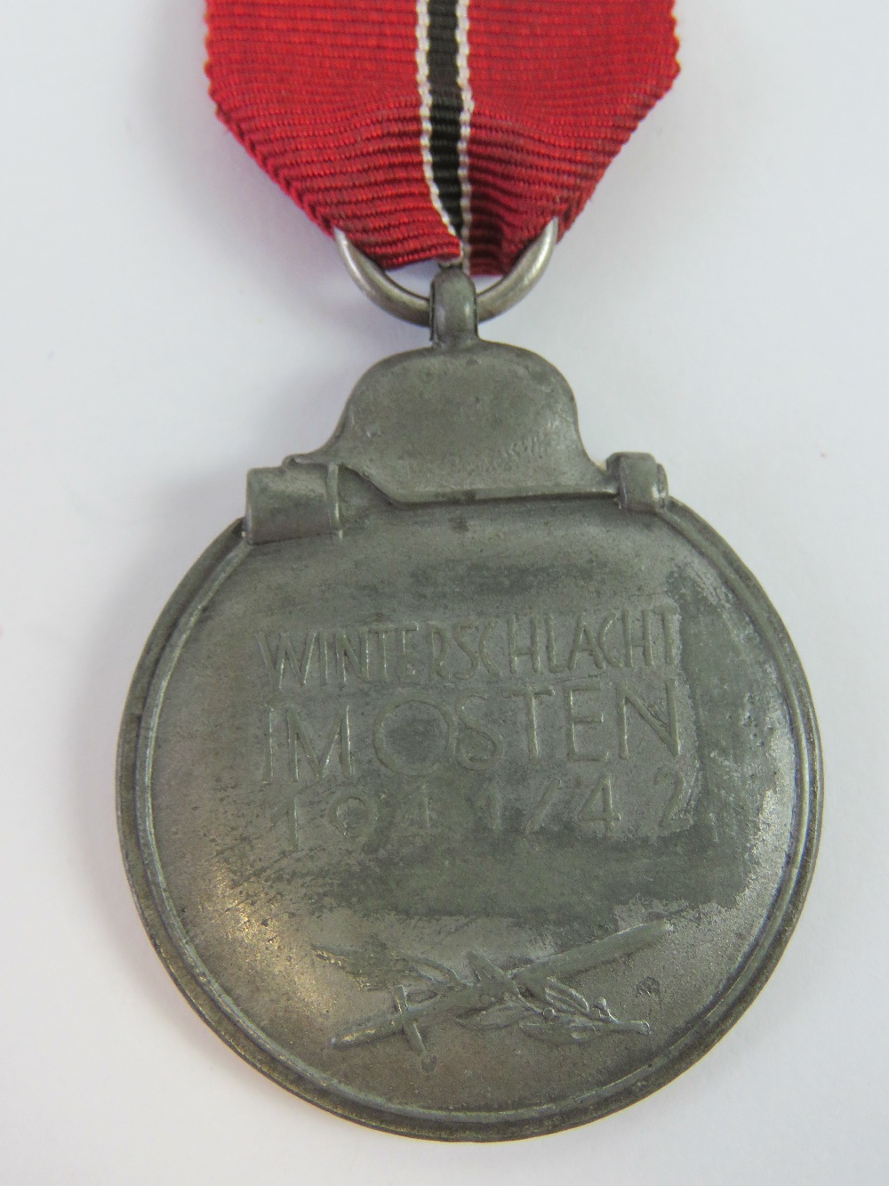 A WWII German Eastern Front 1941/1942 medal with ribbon. - Image 2 of 2