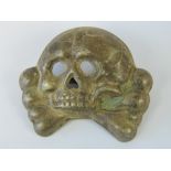 A WWII German SS Deaths head cap badge.