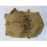 A WWII British Military issue webbing back pack dated 1940 with original carry straps.