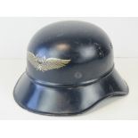 A WWII German Luftschutz 'Lobster Tail' helmet with liner and chinstrap.