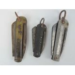 Three WWI Royal Naval issue pocket knives, Sheffield made, one having horn grips.