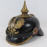 An Imperial German Pickelhaube helmet with Iron Cross design to helmet plate,