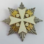 A WWII German Reich 1st Order badge with white cross.