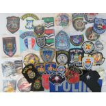 Various cloth police badges including; Metropolitan, Czech Republic, Cayman Islands, Slovenia,