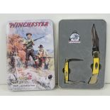 A limited edition Winchester 2005 knife set comprising pocket knife, mini pocket knife and badge,