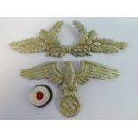 A WWII German Diplomatic Corp peaked cap Eagle badge set of three.