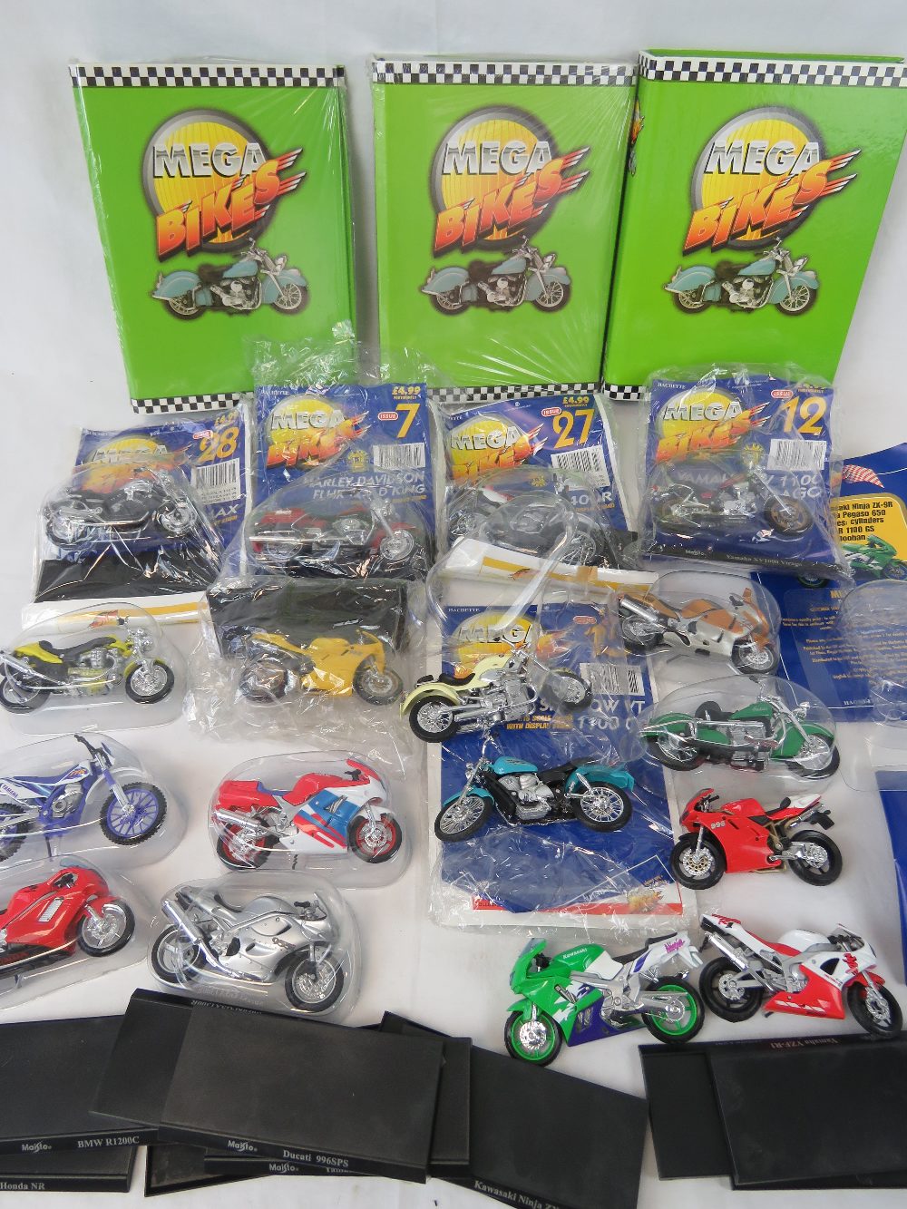 A collection of Mega Bikes die cast model motor bikes, 1:18 scale models with display stands,