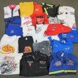A collection of motor sports shirts and T-shirts, some with sponsorship logos, etc.